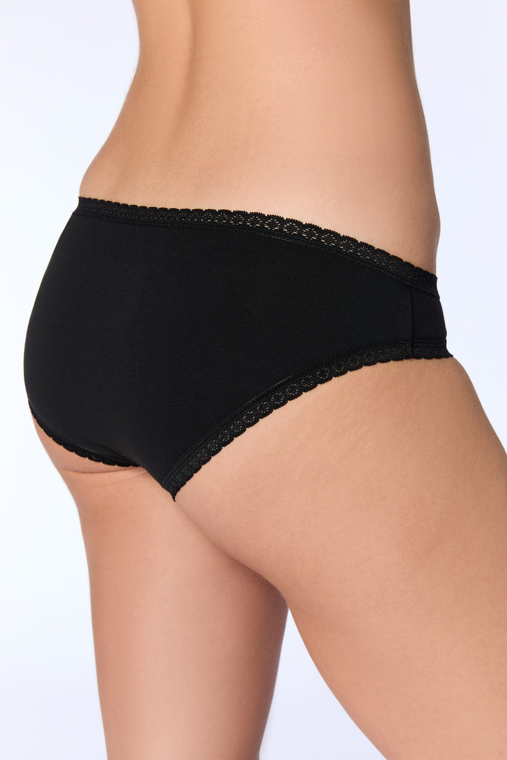 Women's organic cotton lace briefs in black, back three-quarter view on model