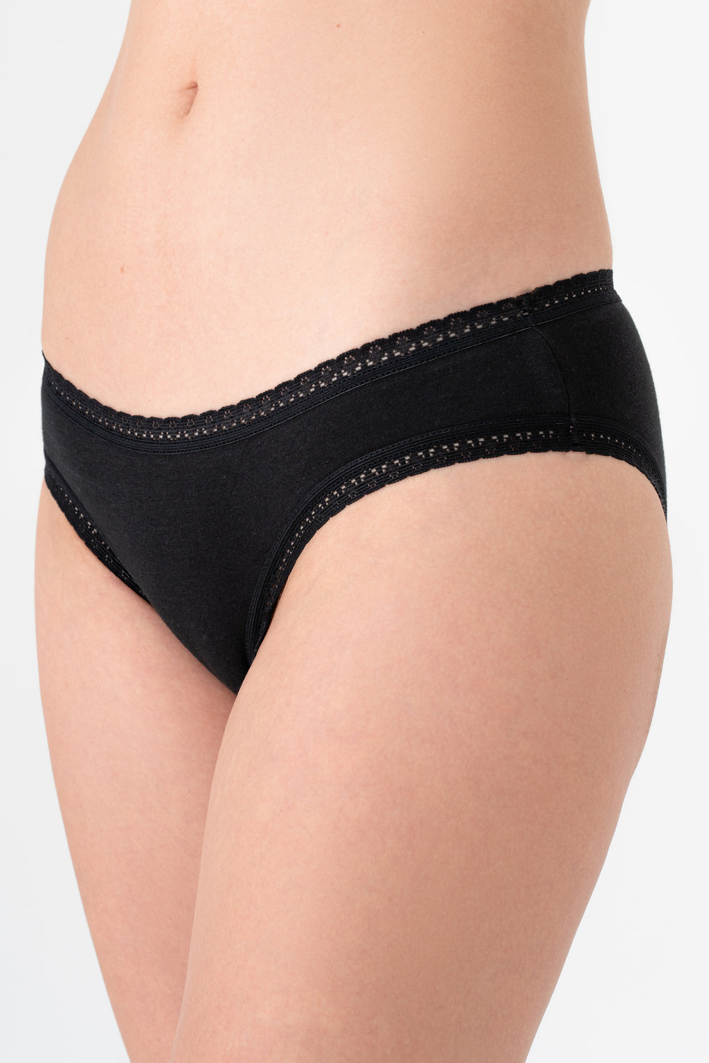 Women's organic cotton lace briefs in black, side view on model