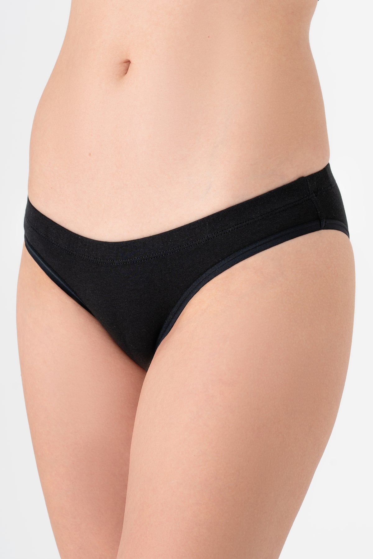 Women's organic cotton briefs in black, side view on model