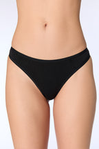 Women's organic cotton thong in black, front view on model