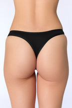 Women's organic cotton thong in black, back view on model