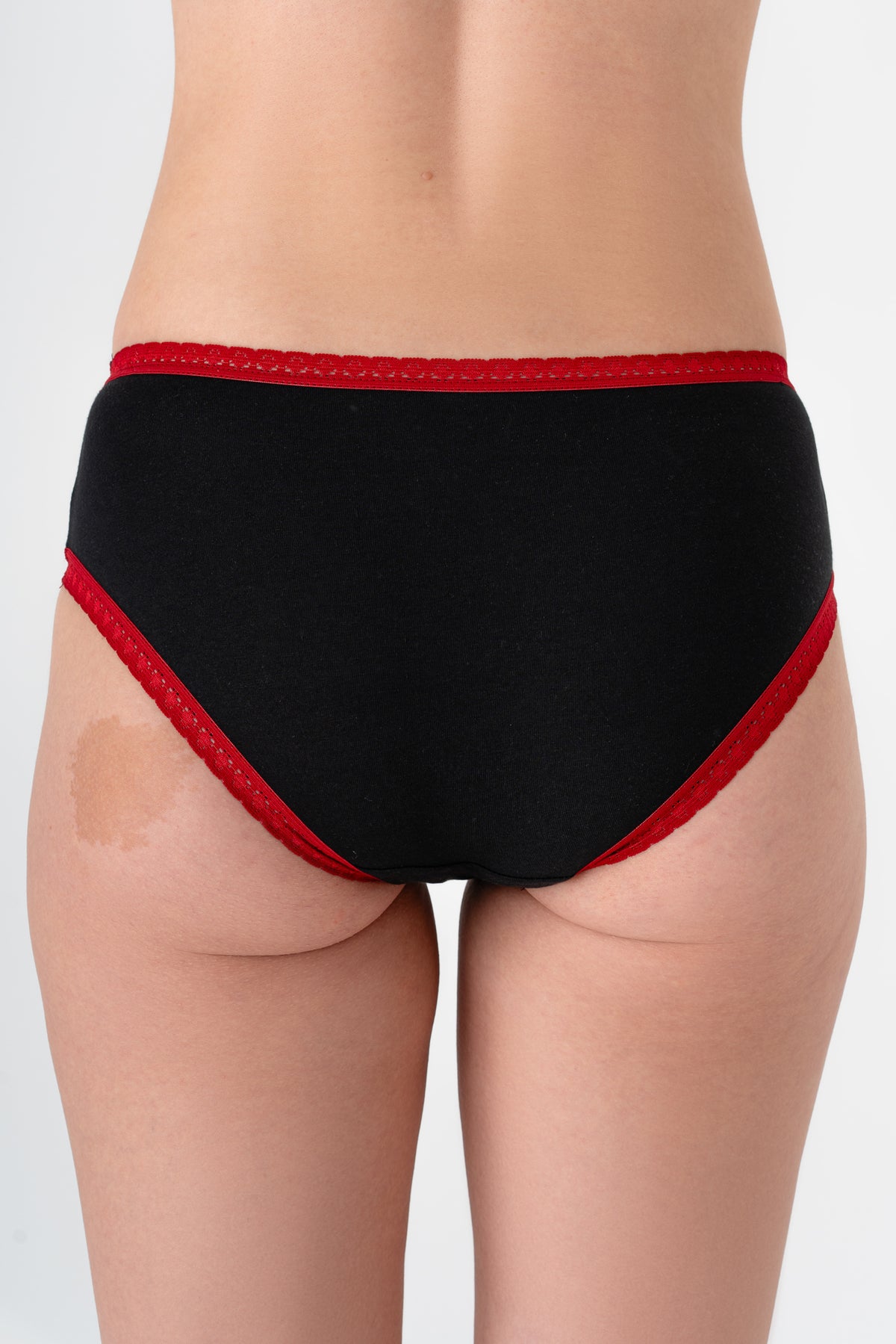 Women's organic cotton hipster in black with red lace trim and bow, back view on model
