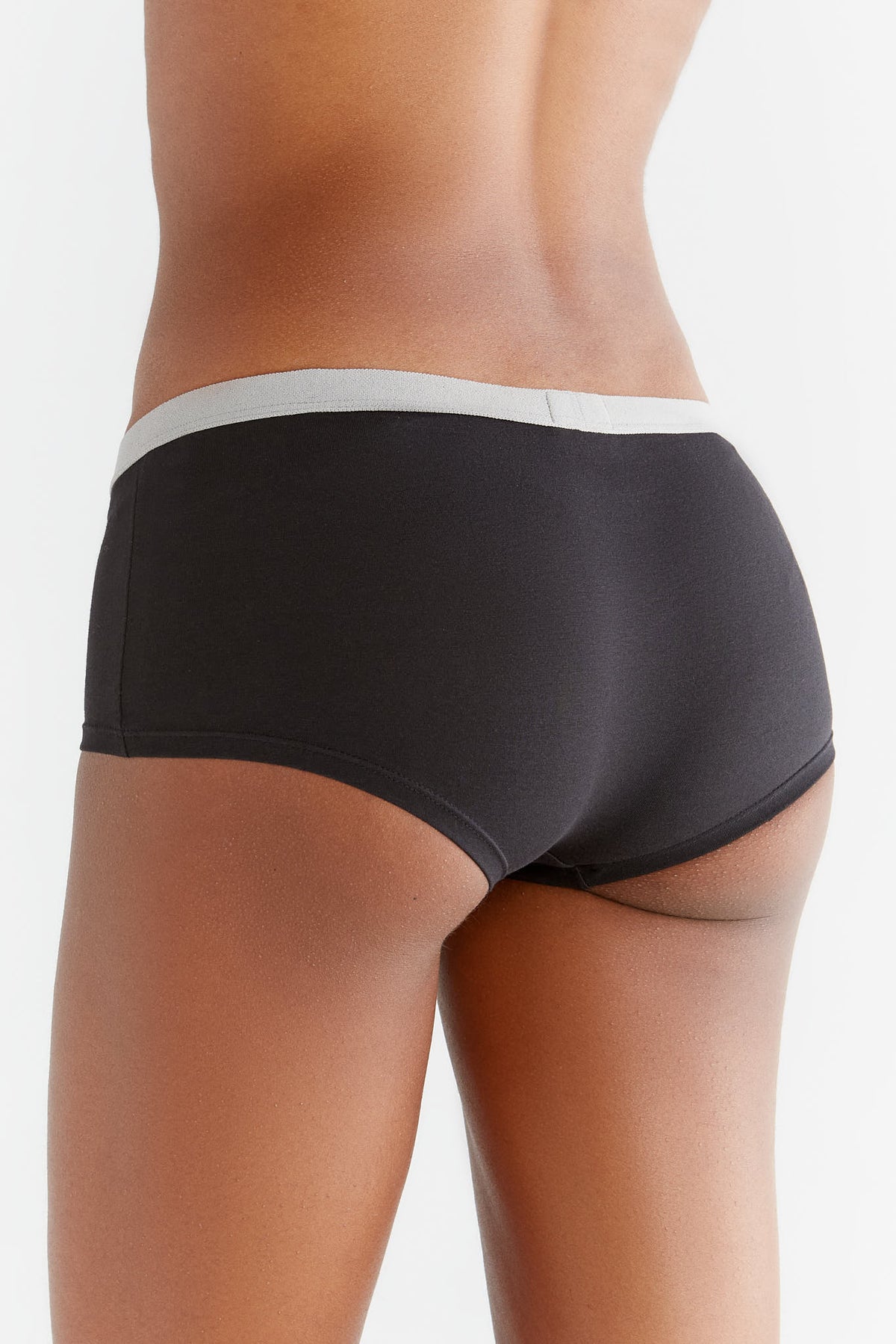 Women's organic cotton boyshorts in black with grey waistband, back view on model