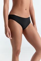 Women's classic organic cotton briefs in black, side view on model