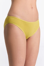 Women's classic organic cotton briefs in lime, side view on model