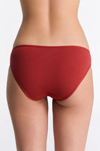 Women's classic organic cotton briefs in red, back view on model