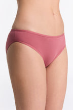 Women's classic organic cotton briefs in Faded Rose, side view on model