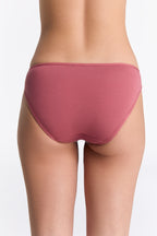 Women's classic organic cotton briefs in Faded Rose, back view on model