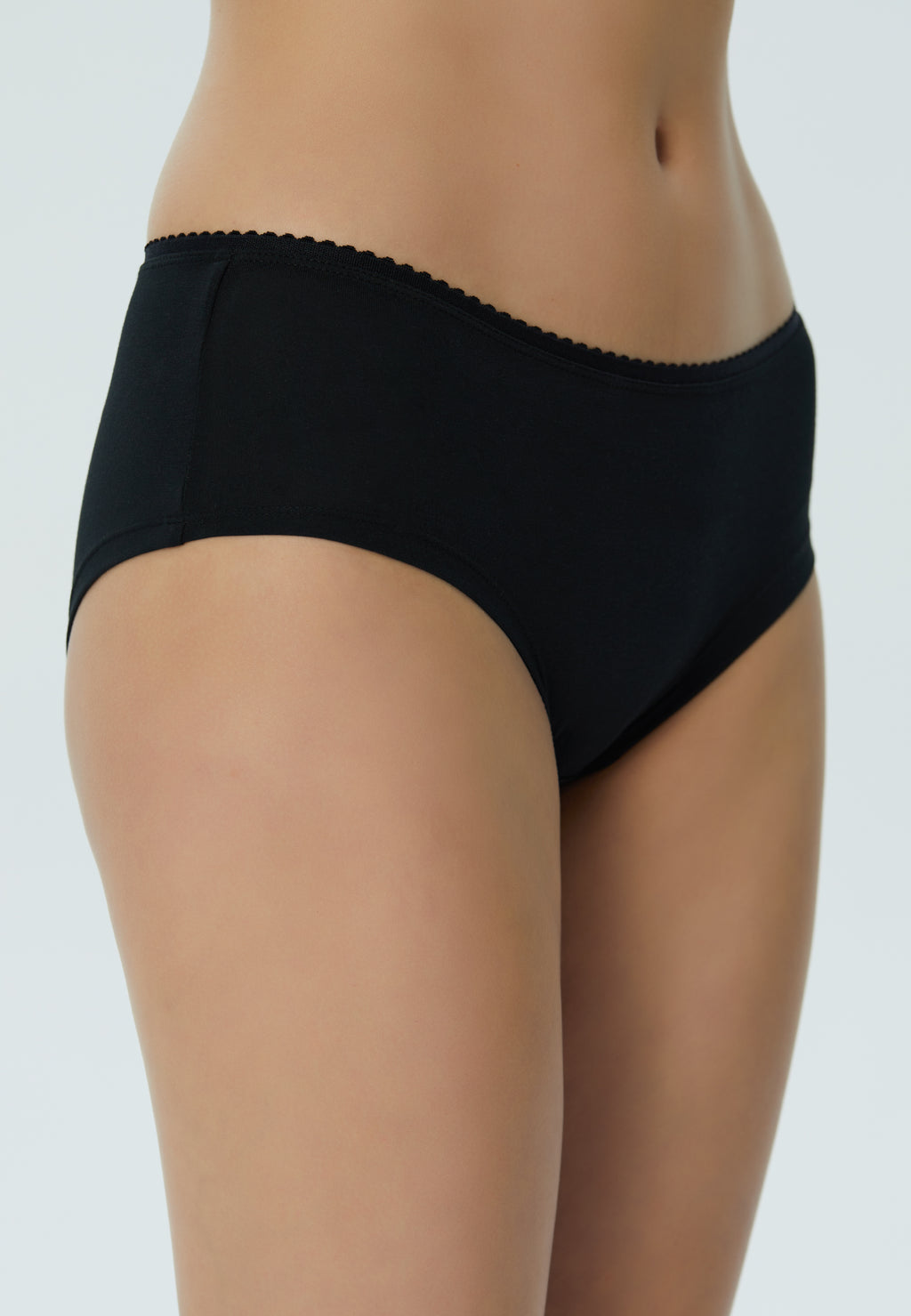 Women's organic cotton hipster with lace waistband in black, side view on model