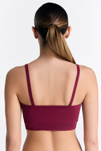 Women's organic cotton bralette in Rosarot, back view on model