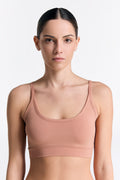 Women's organic cotton bralette in Café Crema, front view on model