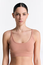 Women's organic cotton bralette in Café Crema, front view on model