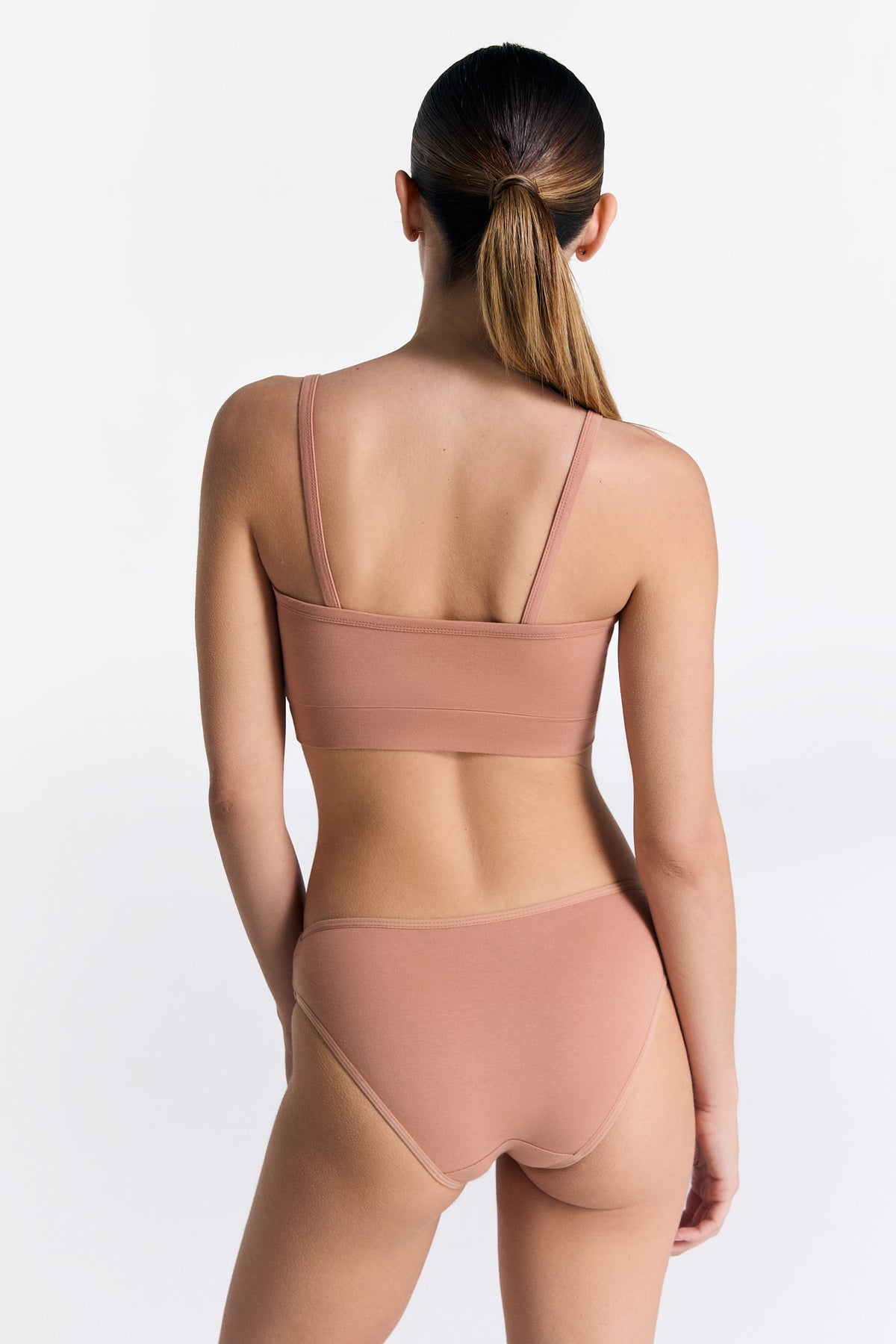 Women's organic cotton bralette in Café Crema, worn with matching classic briefs, back view