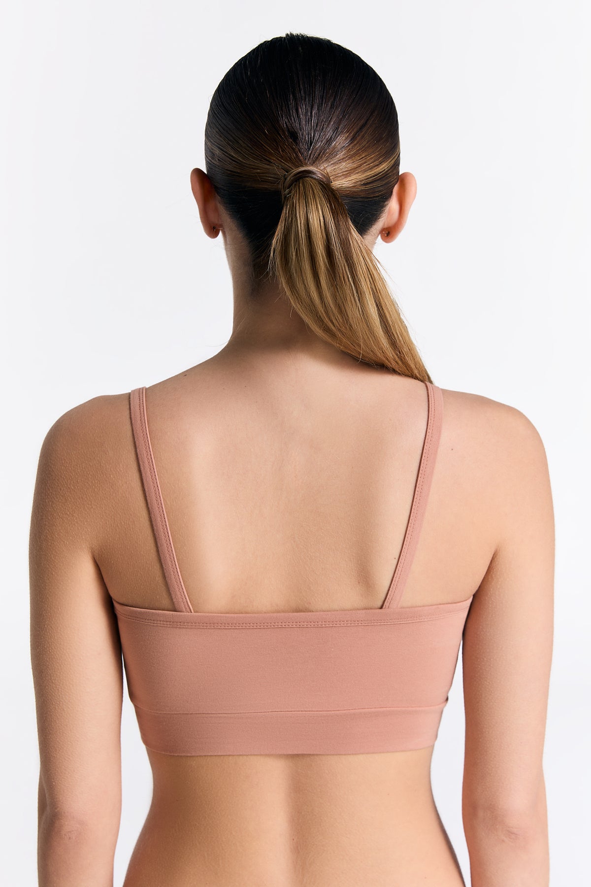 Women's organic cotton bralette in Café Crema, back view on model