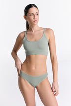 Women's organic cotton bralette in Iceberg Green, worn with matching classic briefs, front view