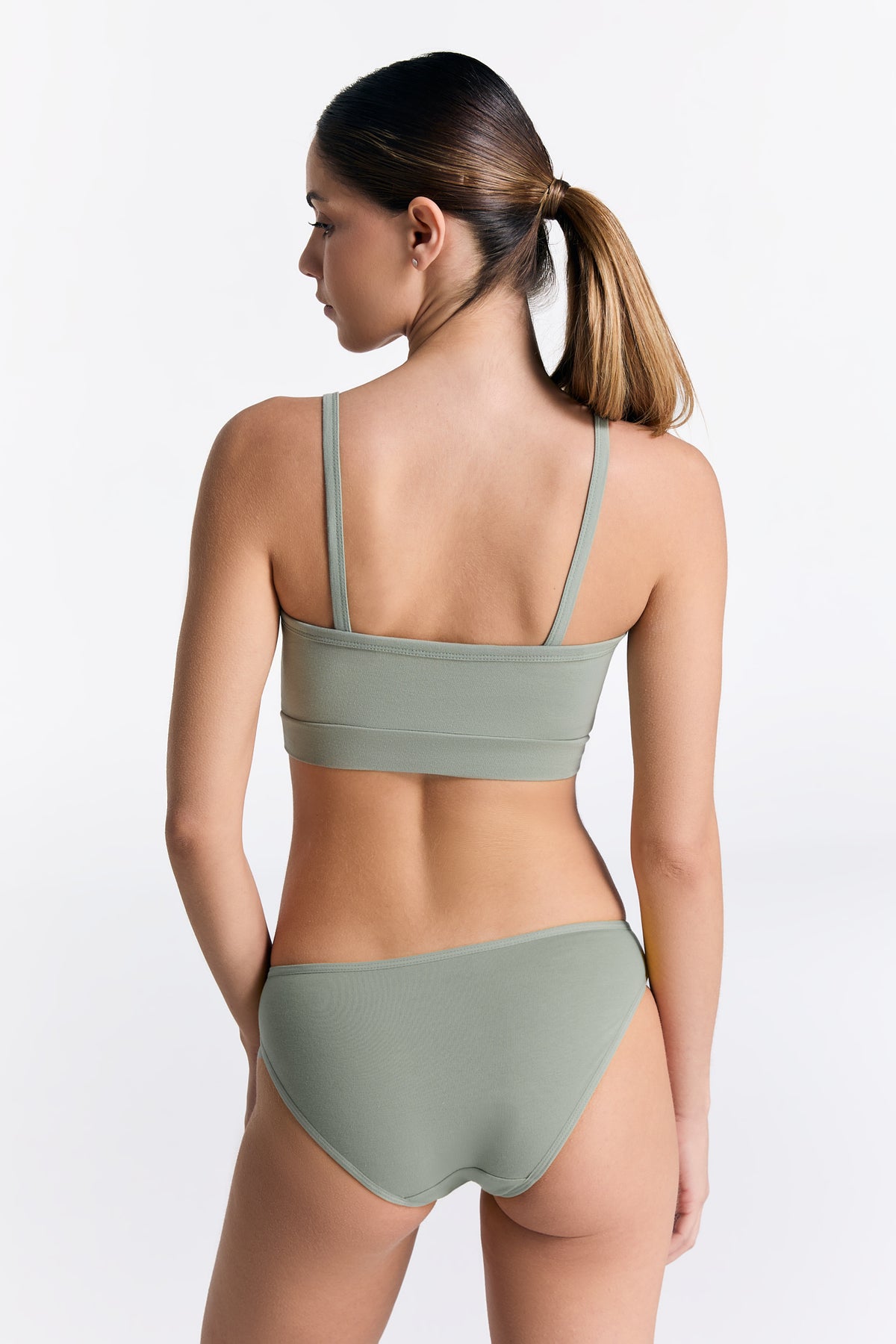 Women's organic cotton bralette in Iceberg Green, worn with matching classic briefs, back view