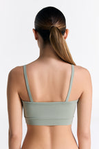 Women's organic cotton bralette in Iceberg Green, back view on model