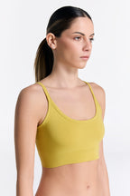 Women's organic cotton bralette in lime, side view on model