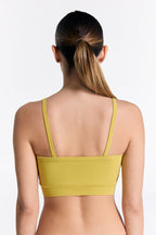 Women's organic cotton bralette in lime, back view on model