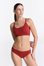 Women's organic cotton bralette in red, worn with matching classic briefs, front view