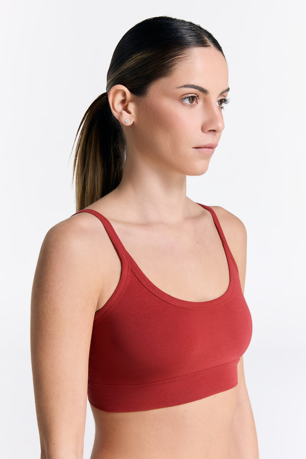 Women's organic cotton bralette in red, side view on model