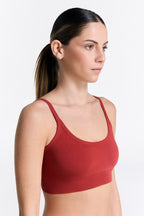 Women's organic cotton bralette in red, side view on model