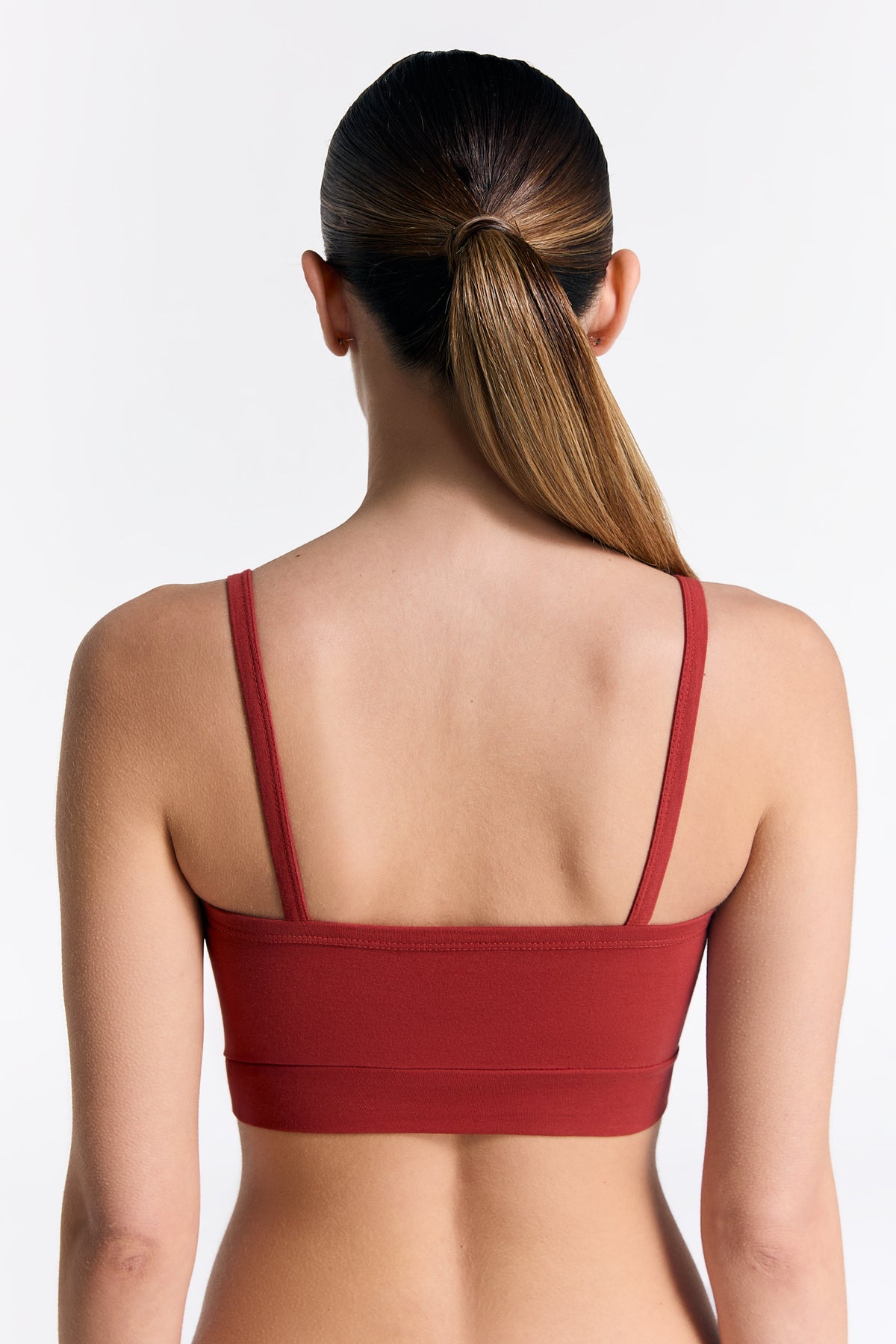 Women's organic cotton bralette in red, back view on model