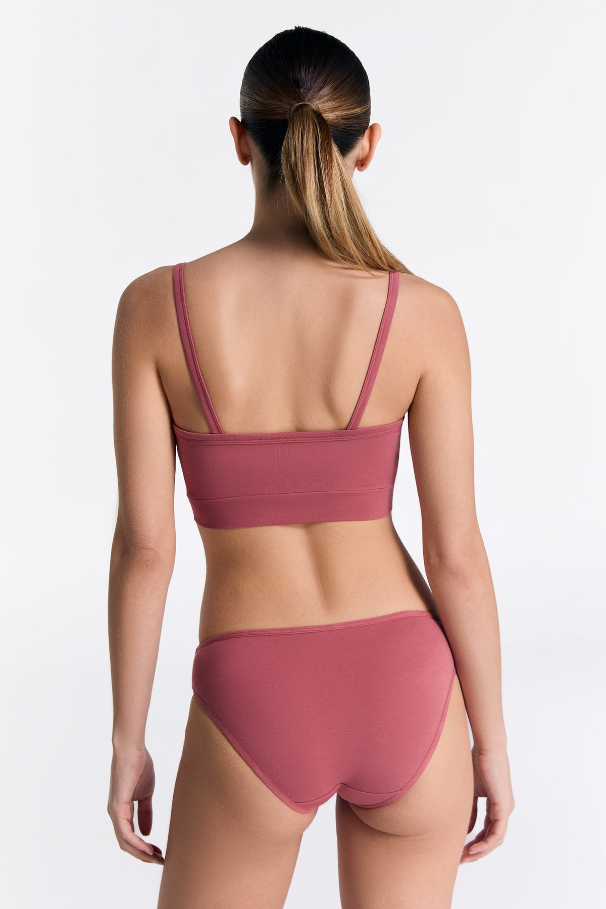 Women's classic organic cotton briefs in Faded Rose, worn with the matching organic cotton bralette, back view