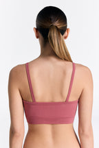 Women's organic cotton bralette in Faded Rose, back view on model