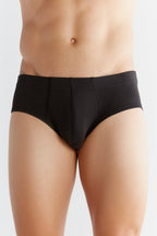Men's organic cotton briefs in black, front view on model