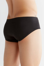 Men's organic cotton briefs in black, back three-quarter view on model