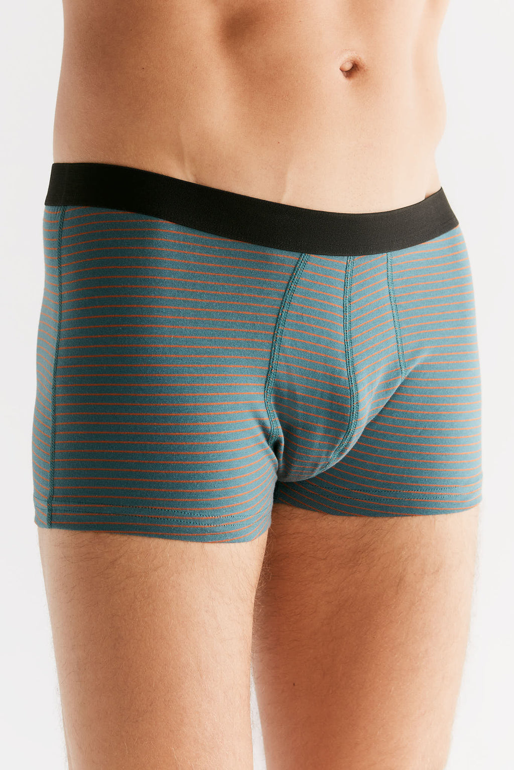 Men's organic cotton trunks in Fir Tabasco, side view on model