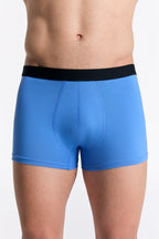 Men's organic cotton trunks in Aquamarine, front view on model