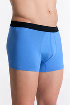 Men's organic cotton trunks in Aquamarine, side view on model