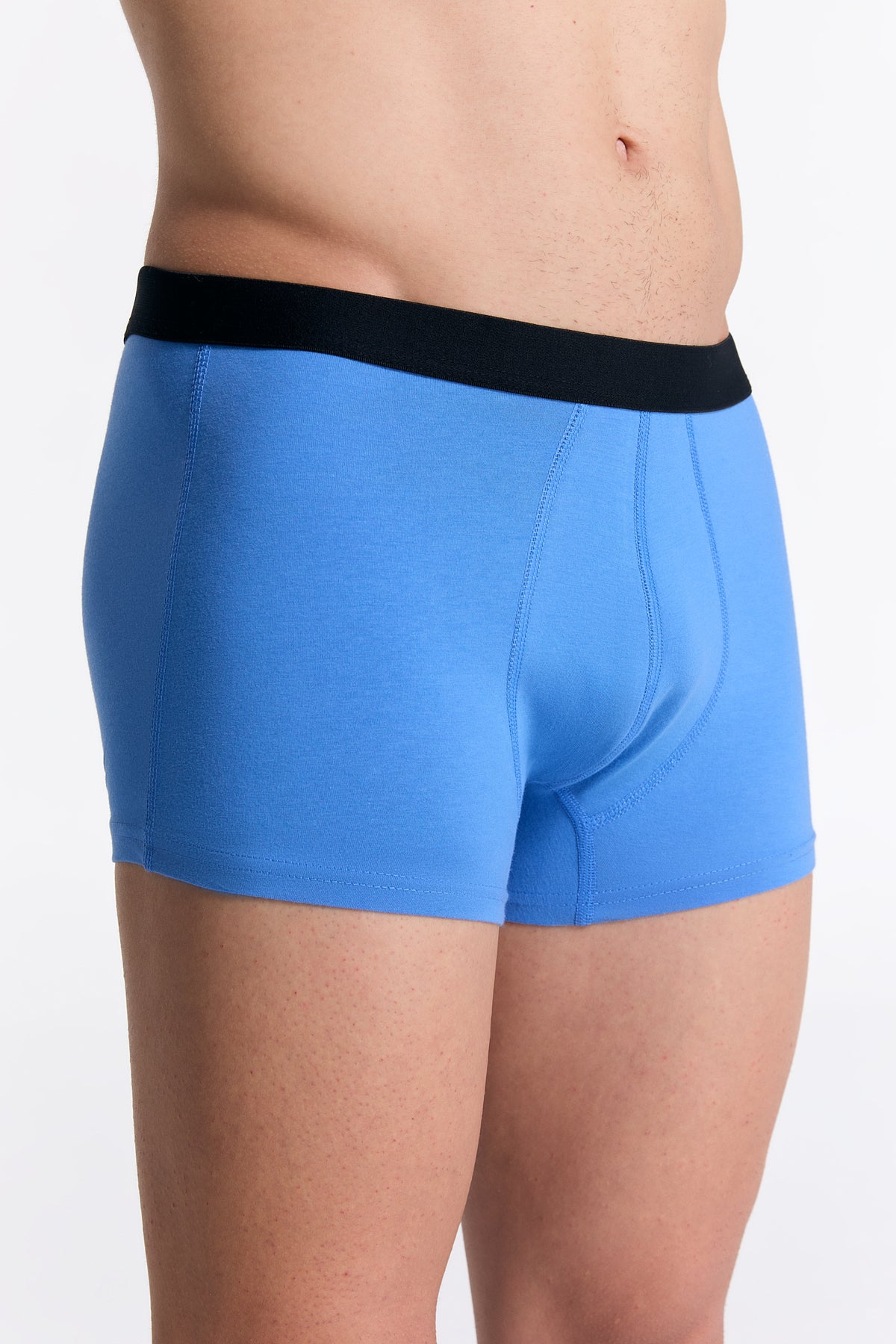 Men's organic cotton trunks in Aquamarine, side view on model