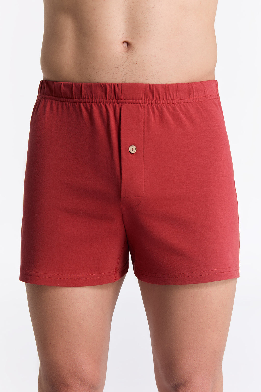 Men's organic cotton boxer shorts in red, front view on model