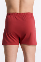 Men's organic cotton boxer shorts in red, back view on model