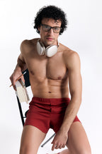 Men's organic cotton boxer shorts in red, lifestyle photo, model seated