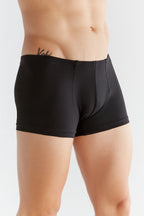 Men's organic cotton boxer briefs in black, side view on model